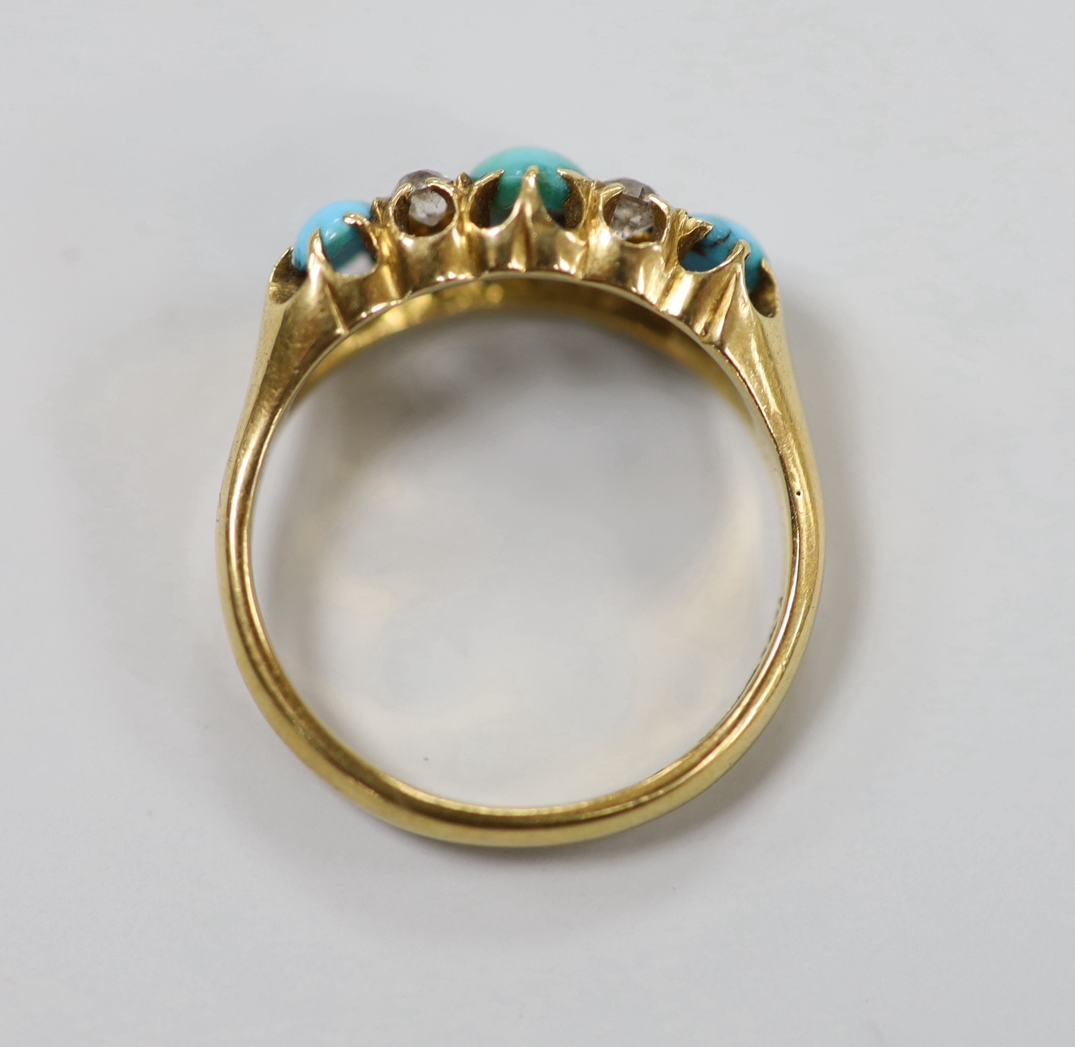 A late Victorian 18ct gold, three stone turquoise and four stone diamond set half hoop ring, size L, gross weight 3.9 grams.